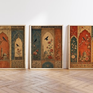 May include: Three framed art prints with an ornate, vintage design. Each print features a central archway design with a mosque, birds, and floral elements in shades of red, blue, and gold. The frames are light wood.