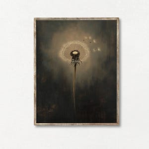 May include: A framed art print featuring a close-up of a dandelion seed head. The artwork has a muted color palette with a dark background and a soft, diffused light highlighting the dandelion. Several seeds are floating away.