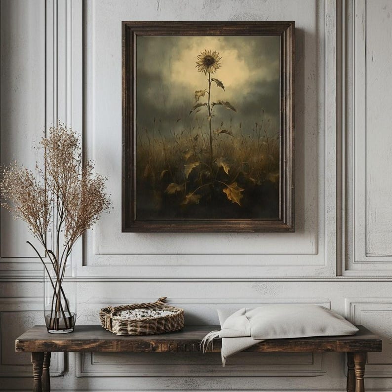 Peut inclure: Une peinture encadr&eacute;e d'un seul tournesol dans un champ. Le tournesol est brun et jaune et est la seule fleur dans le champ. L'arri&egrave;re-plan est gris fonc&eacute; avec un ciel nuageux.