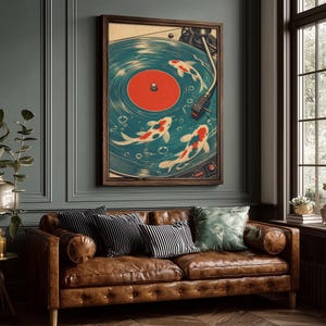 Puede incluir: Una impresi&oacute;n art&iacute;stica enmarcada representa un tocadiscos vintage con peces koi nadando en los surcos del disco. El disco es azul con un centro rojo. Los peces koi son blancos, rojos y negros. El marco es marr&oacute;n.