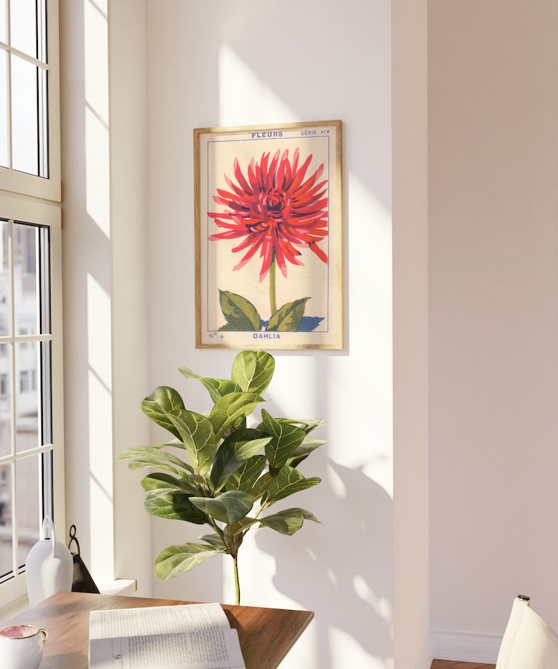May include: Vintage botanical print featuring a red dahlia flower with green leaves. The print is framed in a light wood frame and has the text "FLEURS" and "DAHLIA" in French.