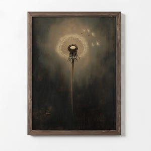 May include: A framed art print featuring a close-up of a dandelion seed head. The dandelion is in the center, with some seeds floating away. The background is a dark, moody color, and the frame is brown.