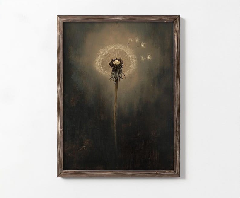 May include: A framed art print featuring a close-up of a dandelion seed head. The dandelion is in the center, with some seeds floating away. The background is a dark, moody color, and the frame is brown.