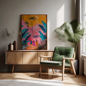 May include: A colorful painting of three women walking through a tropical landscape with palm trees and pink hills. The painting is framed and hanging on a wall above a wooden cabinet and a green armchair.