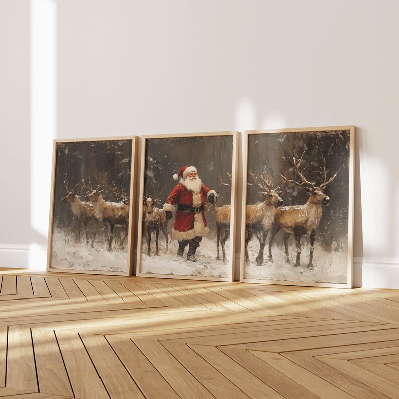 May include: Three framed paintings depicting a winter scene with Santa Claus and reindeer. The paintings are in a rustic style with a snowy background and a forest setting. The paintings are framed in wood with a gold finish.