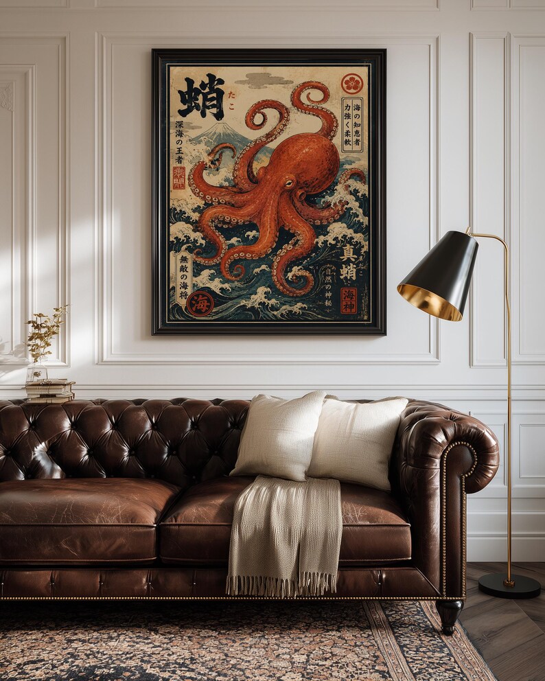 May include: A framed wall art print featuring a large orange octopus centered over stylized blue ocean waves. The artwork includes Japanese kanji characters, a mountain silhouette in the background, and red circular stamps, all set within a black frame.