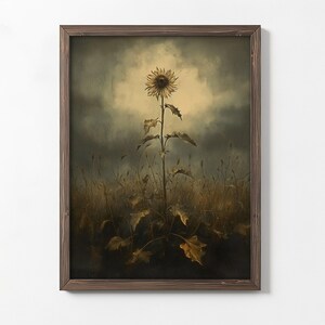 Peut inclure: Une peinture encadr&eacute;e d'un seul tournesol dans un champ. Le tournesol est grand et a un centre jaune avec des p&eacute;tales bruns. Le champ est d'une couleur brun et vert terne, et le ciel est d'un gris fonc&eacute; avec une touche de lumi&egrave;re en arri&egrave;re-plan.