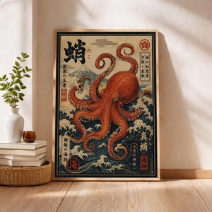 May include: A framed rectangular wall art print featuring a large orange octopus centered over stylized blue ocean waves and a mountain peak in the background. The artwork includes black Japanese kanji characters and red circular seal stamps.