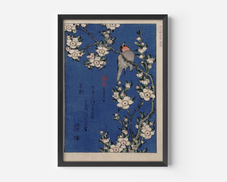May include: A vintage Japanese woodblock print depicting two birds perched on a branch of white blossoms against a blue background. The print includes Japanese text.