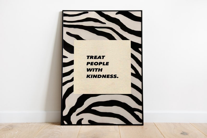May include: A framed print with a black and white zebra print background. The print features the text "Treat People With Kindness."