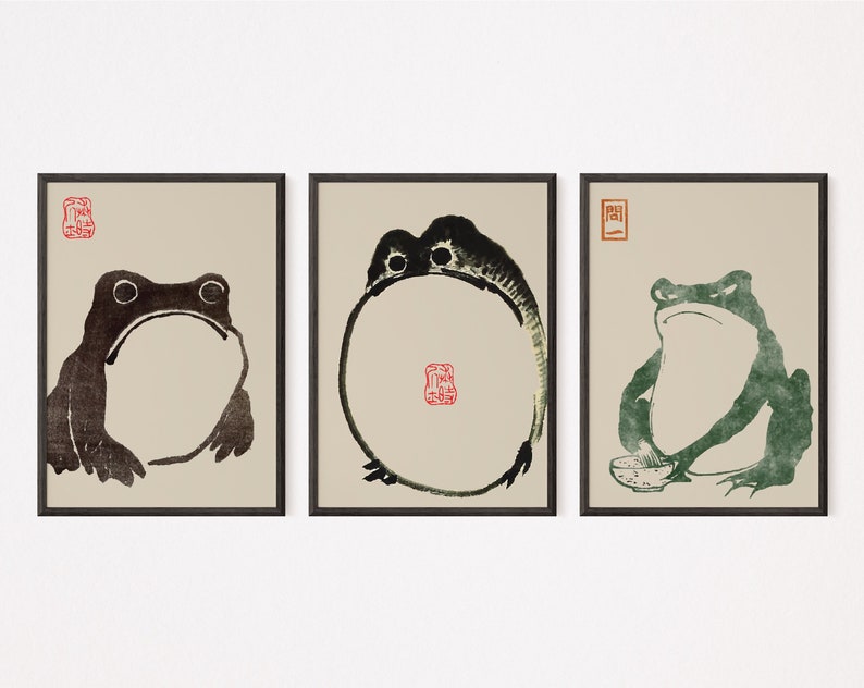 May include: Three framed black and white ink drawings of frogs. The first frog is sitting with its mouth open. The second frog is curled in a circle. The third frog is sitting with a bowl in front of it.