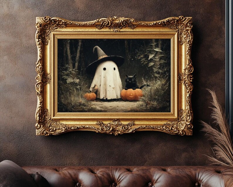 May include: A framed Halloween-themed artwork featuring a ghost wearing a witch hat, a black cat, and pumpkins. The artwork is set in a forest scene and framed in an ornate gold frame, creating a vintage aesthetic.