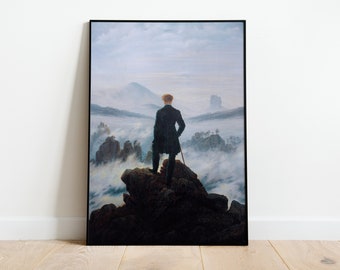 May include: A painting of a man standing on a rocky cliff overlooking a sea of clouds. The man is wearing a dark coat and has his back to the viewer. The sky is a light blue and the clouds are white. The painting is framed in black.