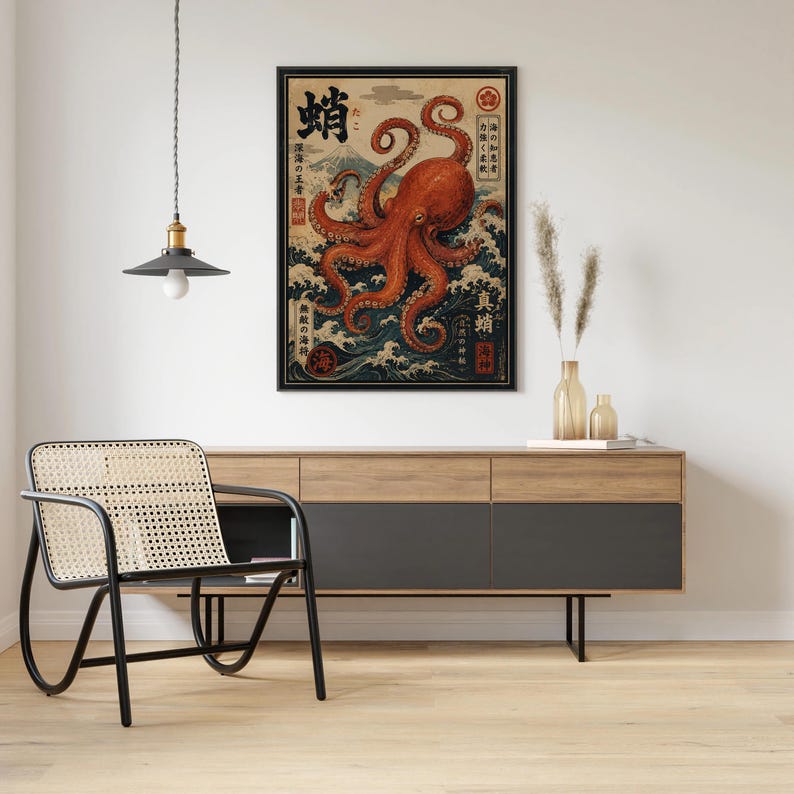 May include: A framed wall art print featuring a large orange octopus centered over stylized blue ocean waves and a mountain in the background. The artwork includes black Japanese kanji characters and red circular stamps arranged vertically and horizontally.