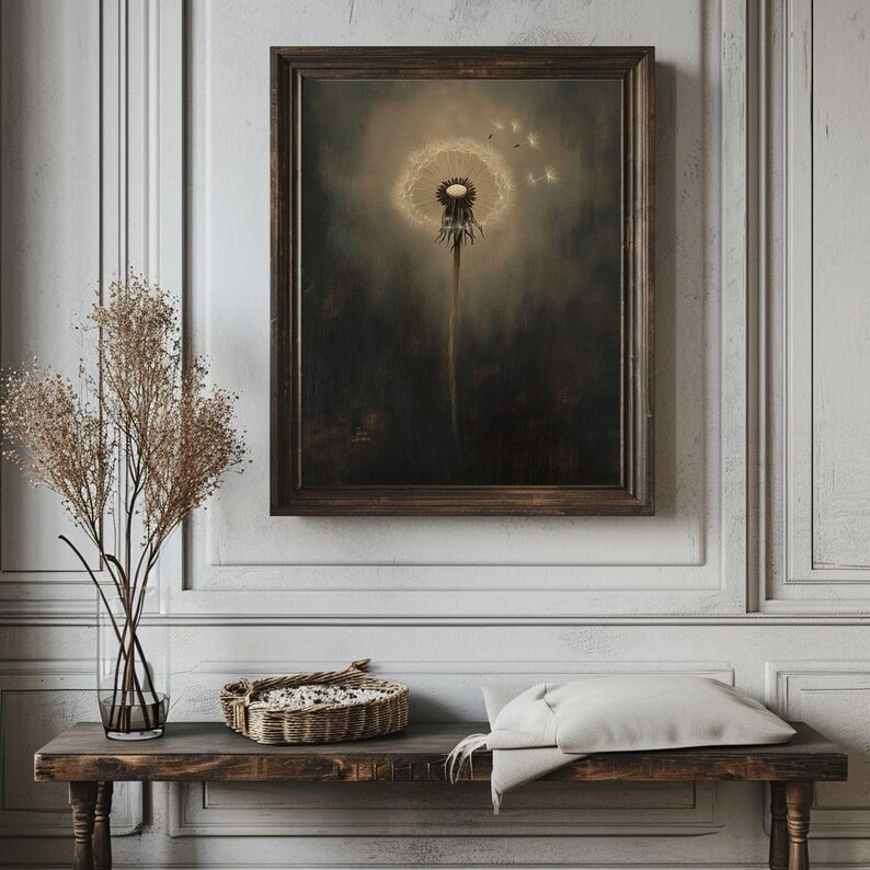 May include: A framed art print featuring a detailed dandelion seed head with a soft, glowing center. The artwork is set against a dark, moody background, creating a striking contrast. The frame is a dark brown color.