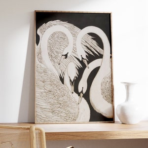 May include: A framed black and white illustration of three white swans with their necks intertwined. The swans are drawn in a detailed, realistic style.