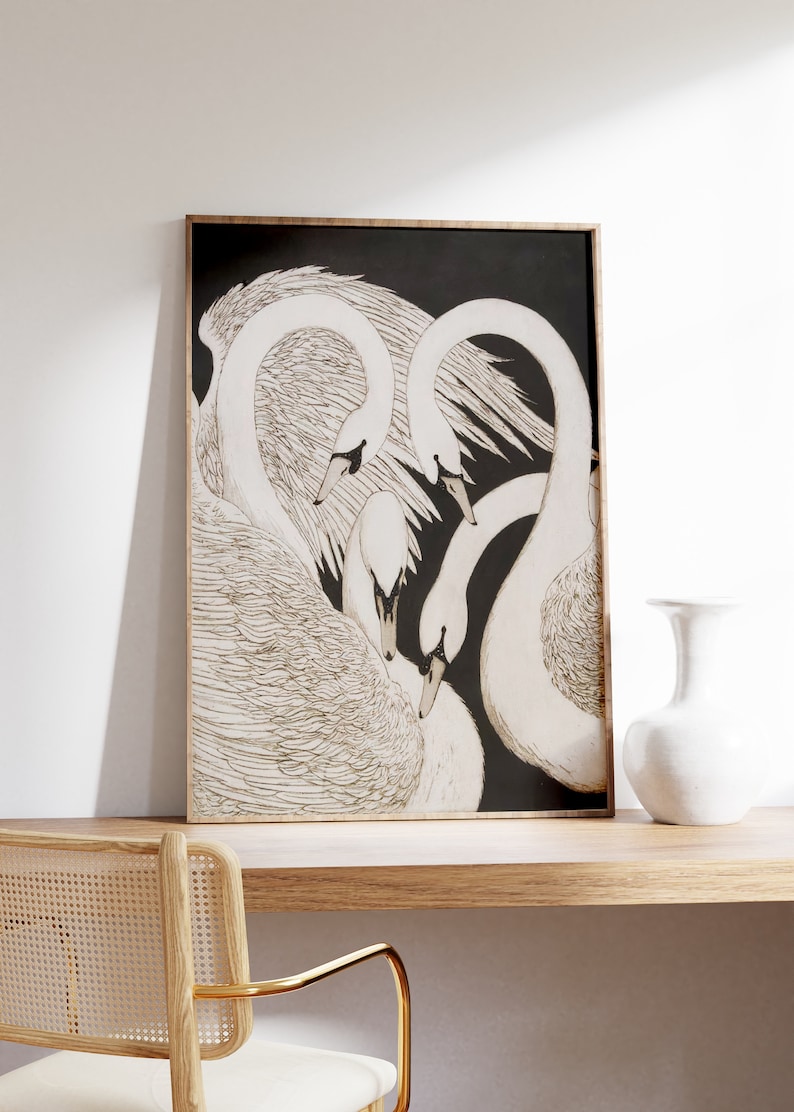 May include: A framed black and white illustration of three white swans with their necks intertwined. The swans are drawn in a detailed, realistic style.