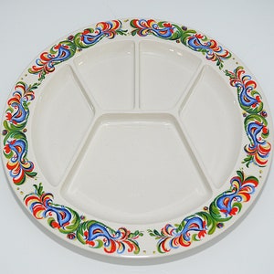 May include: A white ceramic serving platter with a decorative border of blue, red, green and yellow floral designs. The platter is divided into five sections.