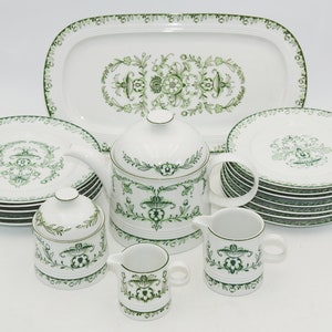 May include: A vintage tea set with a green floral pattern. The set includes a teapot, creamer, sugar bowl, and six teacups and saucers.