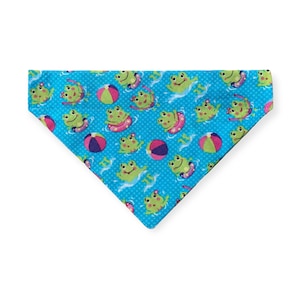 May include: A blue bandana with a pattern of green frogs wearing pink inner tubes and floating on blue water with red and white beach balls.