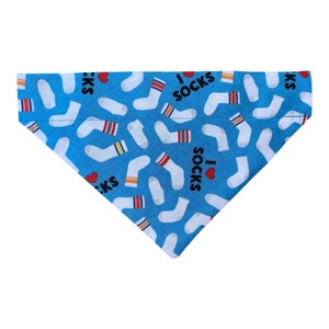 May include: A blue dog bandana with a white sock pattern and the text "I love socks" repeated throughout.