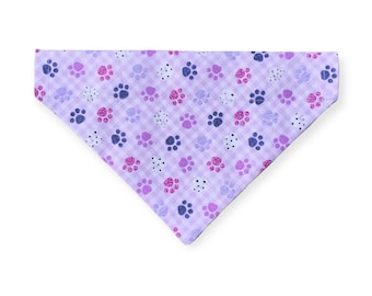 May include: A purple bandana with a white gingham pattern and pink and blue paw prints.