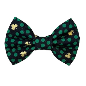 May include: A black bow tie with green polka dots and gold shamrock accents.