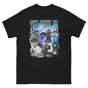 May include: Black t-shirt with a graphic print of a group of people in front of a blue and white wave design. The text "THE TOUR 25" is printed in white above the graphic. The graphic also includes the text "DUB-SACK" and "508".