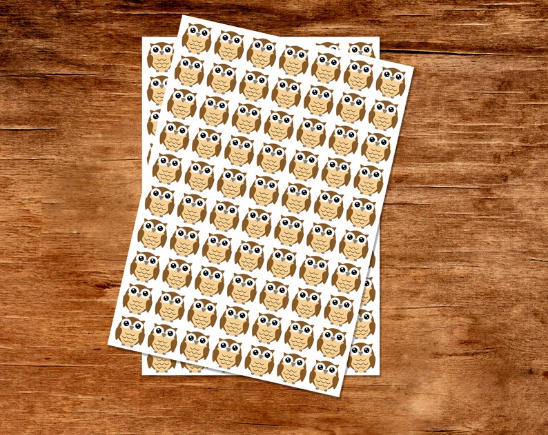 Puede incluir: Dos hojas de papel blanco con pegatinas de b&uacute;ho marrones. Cada hoja tiene 49 pegatinas de b&uacute;ho.