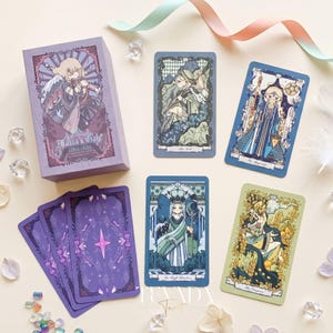 May include: A Maria's Gate tarot deck featuring a purple box with an illustrated character, four distinct tarot cards depicting stylized figures, and three purple card backs with a central star design, all arranged on a light surface.