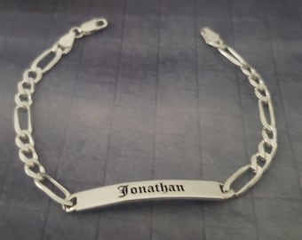 May include: Silver chain bracelet with a personalized nameplate engraved with the name "Jonathan".