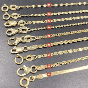 May include: A selection of nine gold necklaces with different chain styles, including oval links, beaded, and rope designs. Each necklace is shown with a clasp and labeled with a number from #1 to #9. The necklaces are displayed on a dark surface.