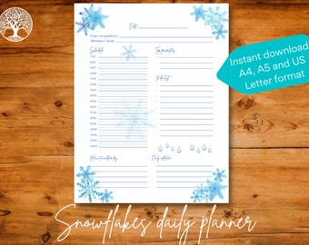 May include: A printable daily planner with a snowflake theme. The planner has sections for scheduling, top priorities, to-do list, and daily reflection. The background is white with blue snowflakes and raindrops.