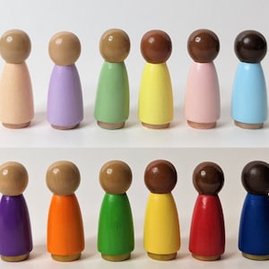 May include: Set of 12 wooden peg dolls painted in various colors, including peach, lavender, green, yellow, pink, blue, purple, orange, green, yellow, red, and blue.