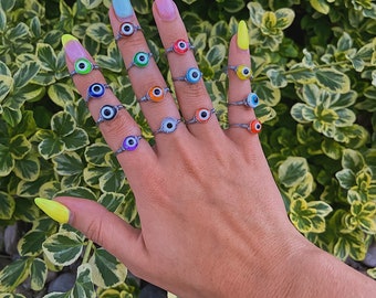 silver wire-wrapped evil eye rings