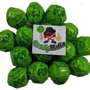 May include: A close-up of a group of green Tootsie Roll Pops, a popular candy. The candy is wrapped in green foil with the Tootsie Roll logo and the words "Pop" and "Lemon Lime".