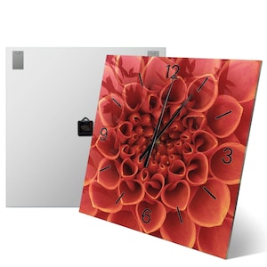 May include: A square wall clock featuring a high-resolution print of a vibrant orange dahlia flower. The clock face displays black numerals at the 3, 6, 9, and 12 o'clock positions, with thin black hour and minute hands centered on the floral image.