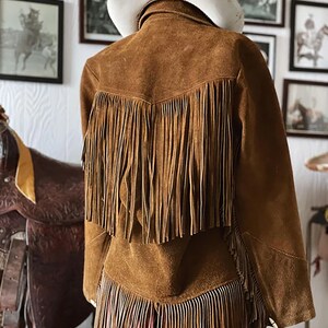Fringe suede brown leather cowgirl jacket, fringed at back.