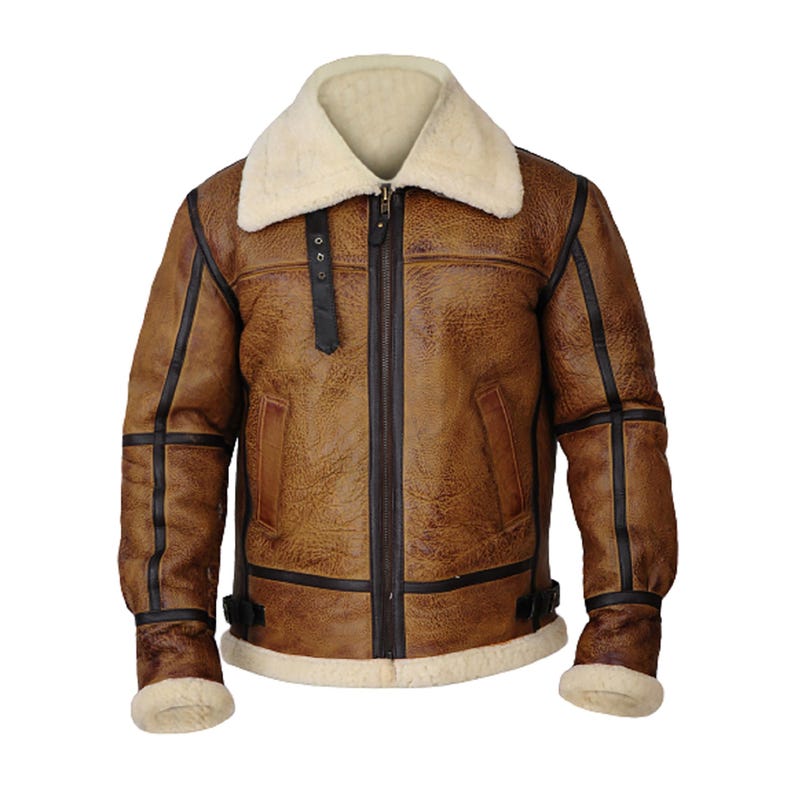 May include: Brown leather jacket with a cream-colored shearling collar and lining. The jacket features a zip-up front, black trim, and a classic aviator style. The cuffs and hem are lined with cream-colored shearling.