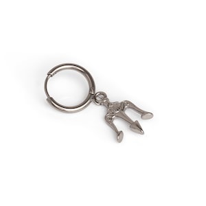 May include: Silver hoop earring with a trident charm hanging from it.