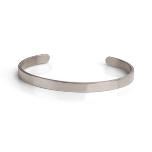 May include: A silver bangle bracelet with a smooth, polished finish.