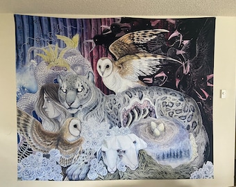 May include: A large tapestry featuring a detailed illustration with a snow leopard, owls, and crows. The artwork incorporates elements of nature, including a nest with eggs, roses, and a forest scene, with a palette of blues, whites, and blacks.