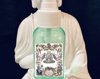 May include: A clear glass bottle with a white spray top and a green label that says "Florida Water" with a floral design. The bottle is sitting on a white statue.