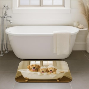 May include: A bath mat featuring three golden retriever puppies in a vintage-style bathtub filled with bubbles. The puppies are wearing bath hats and appear to be enjoying their bath time. The mat is rectangular and placed in front of a white bathtub.
