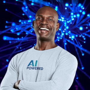 May include: A person smiling, wearing a light grey long-sleeved shirt with the text "AI POWERED" in blue and white. The background is a dark blue gradient with bright blue glowing light strands.