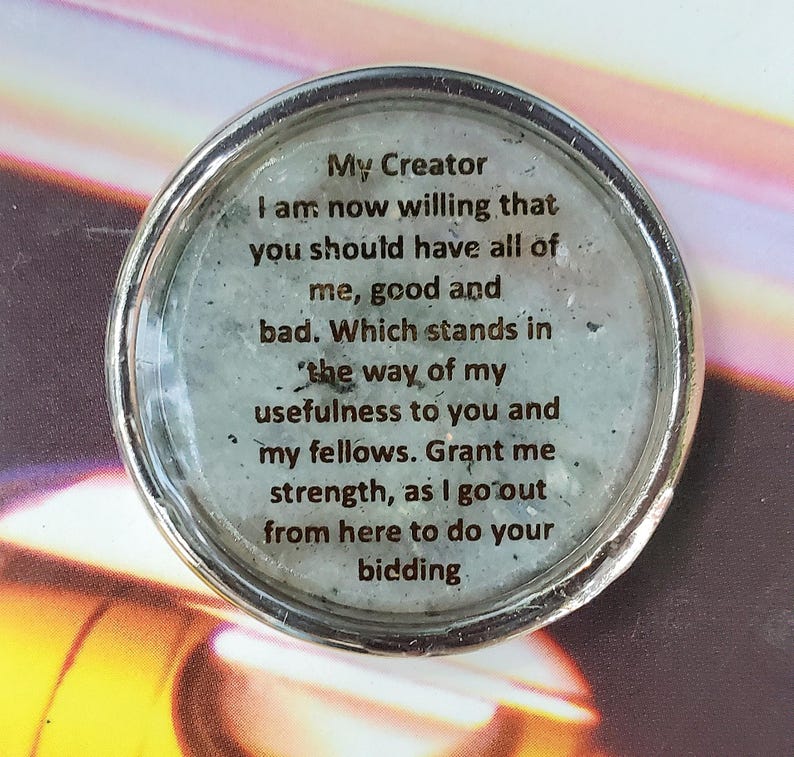 May include: A circular silver-toned metal charm featuring a light gray speckled background under a clear glass dome. The text reads: My Creator I am now willing that you should have all of me, good and bad. Which stands in the way of my usefulness to you and my fellows. Grant me strength, as I go out from here to do your bidding.