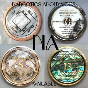 May include: Four circular Narcotics Anonymous recovery medallions with metallic rims. The coins feature the NA symbol, the text 'THAT NO ADDICT SEEKING RECOVERY NEED EVER DIE', and various numbers like 5 and 13, set against white, iridescent, and textured backgrounds.