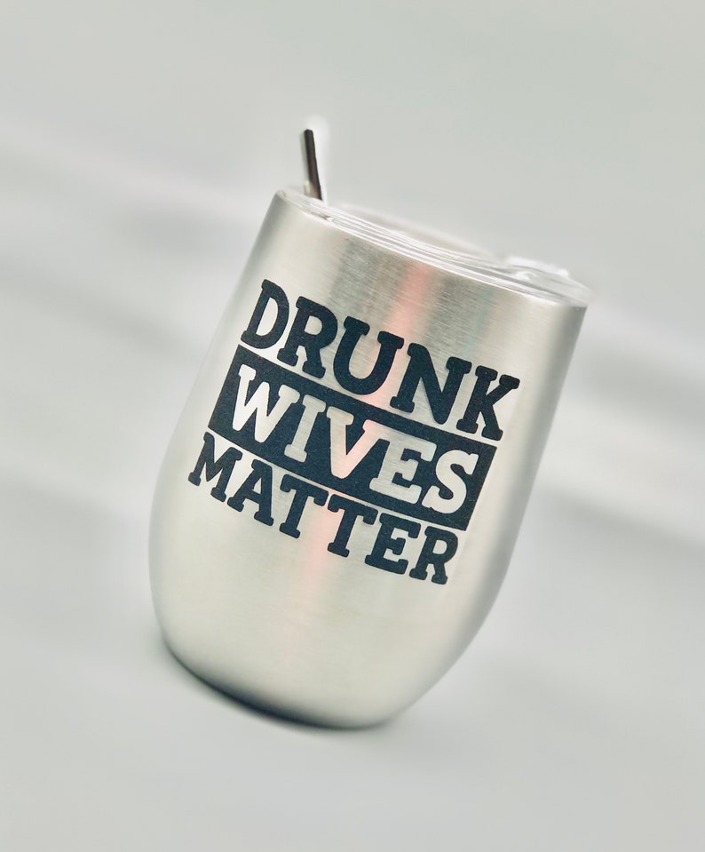 May include: Stainless steel wine tumbler with a black inscription that reads "Drunk Wives Matter".