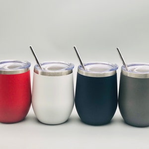 May include: Four stainless steel wine tumblers with lids and straws. The tumblers are red, white, black, and gray.