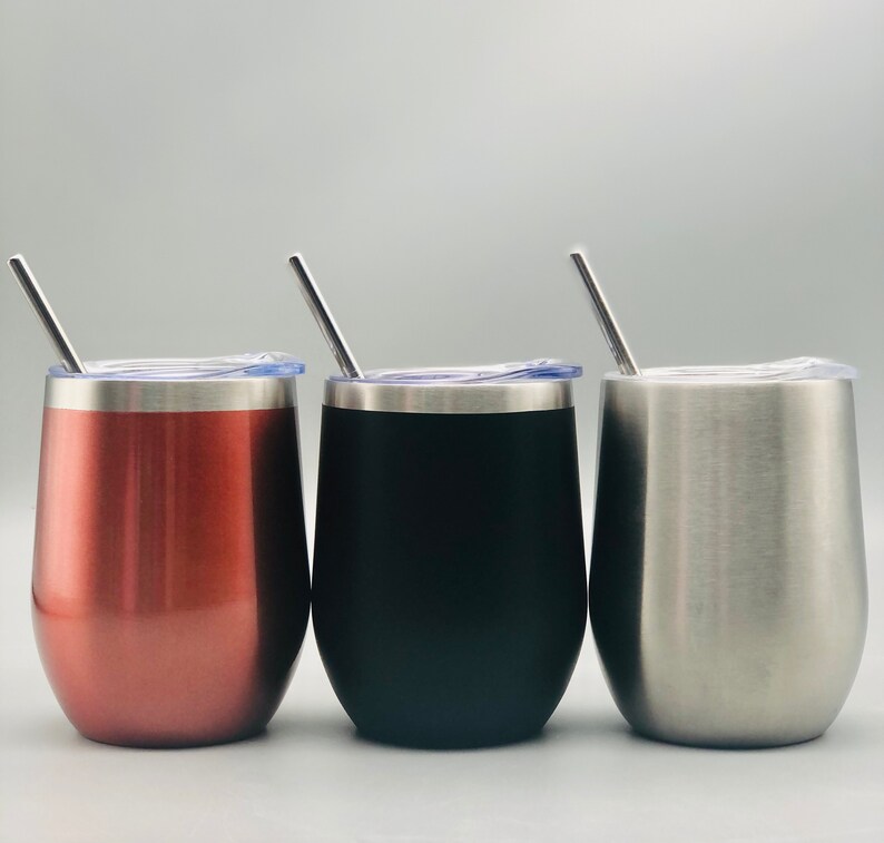 May include: Three stainless steel wine tumblers with lids and straws. The tumblers are in rose gold, black, and silver.